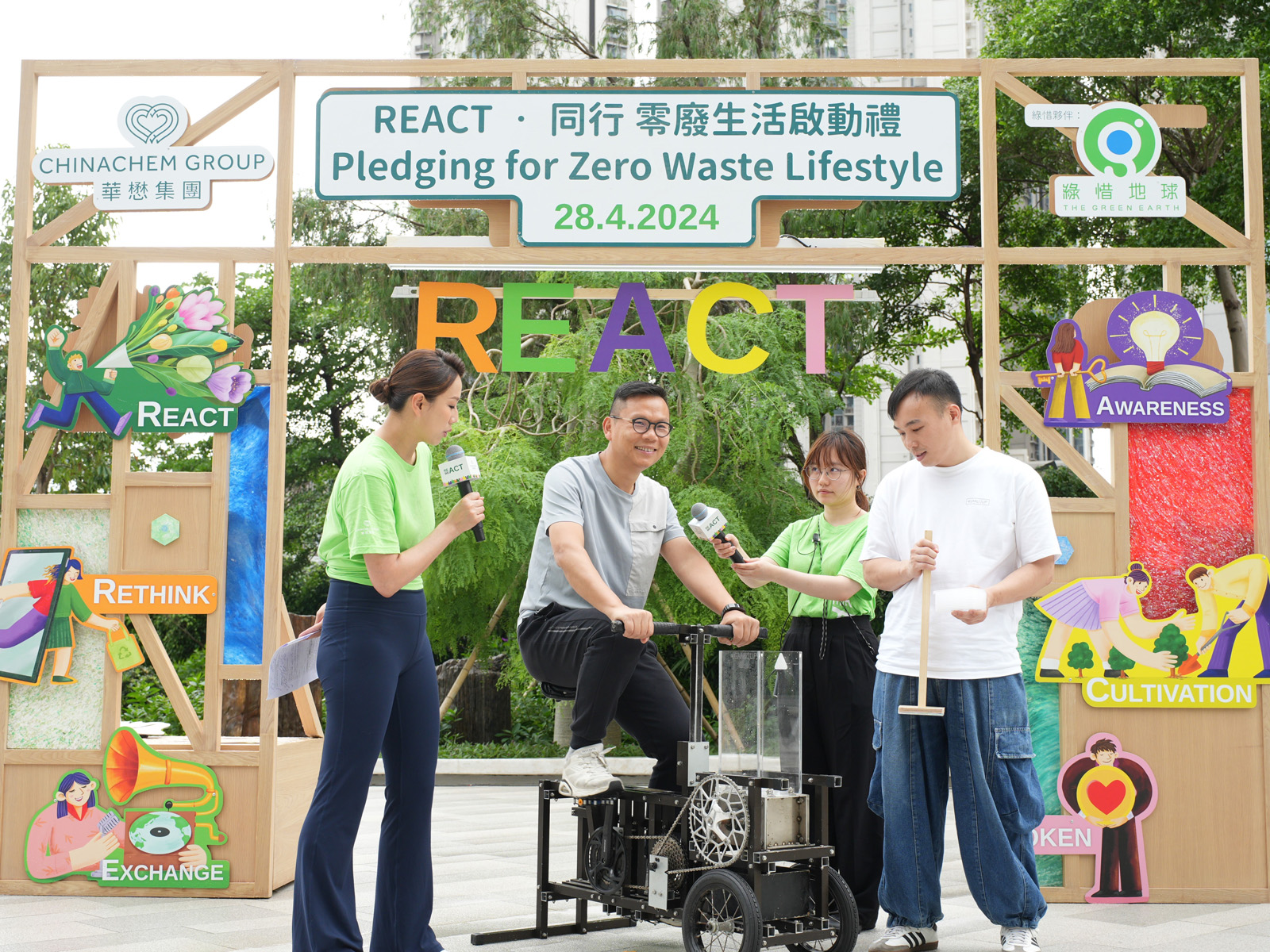 Legislative Council member Ben Chan is invited on stage to try out a specially-designed bicycle