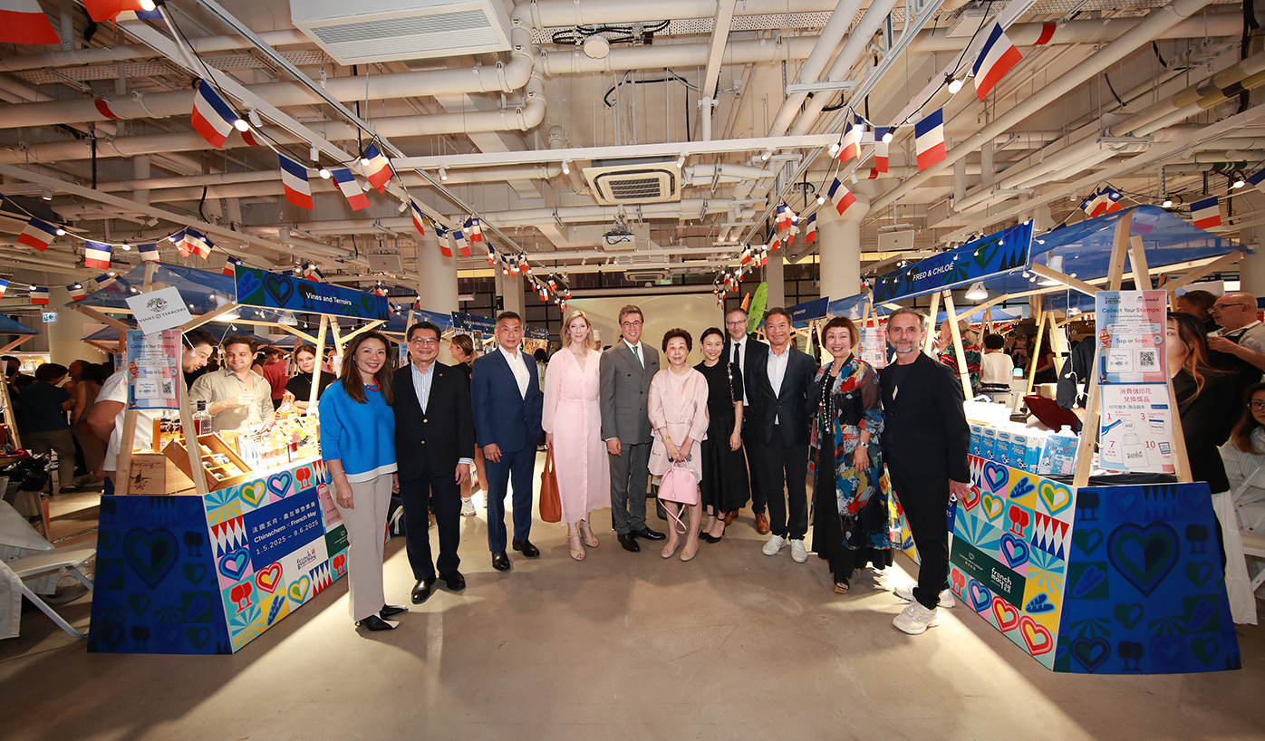 The officiating party and guests tour the French GourMay Market at Central Market